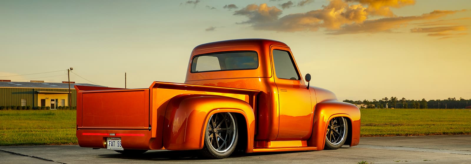 Photo of the 2022 competition winner. A car sillhouetted against a sunset in front of a cornfield.